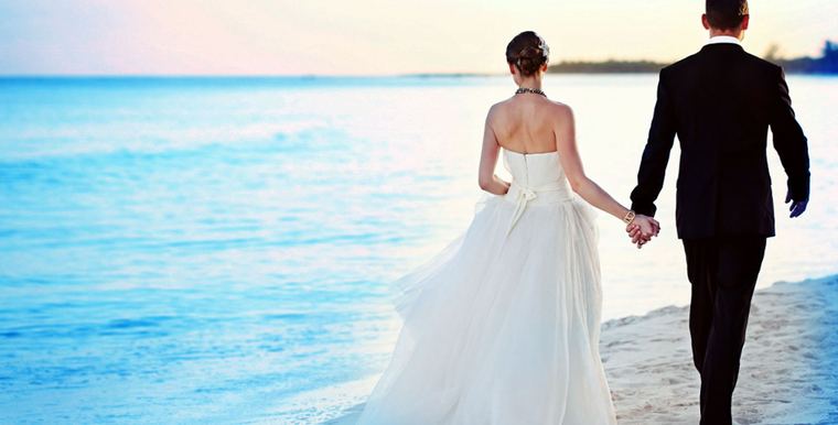 Couple walking the tideline at the end of the day