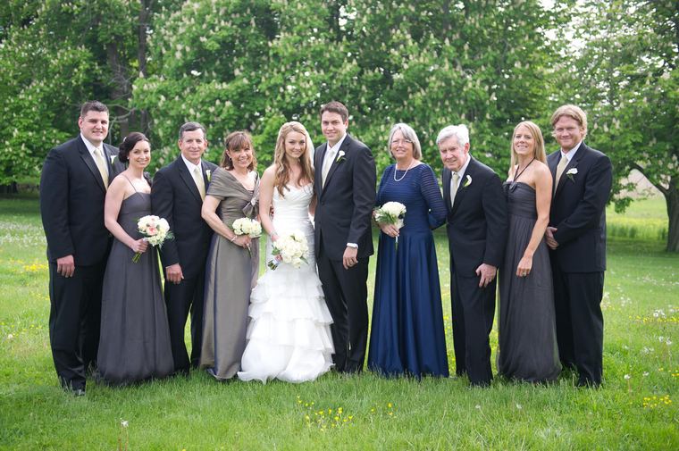 Full wedding party arranged on a lawn