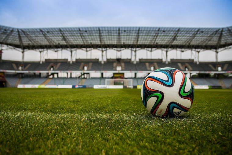 Match ball on the centre spot in an empty ground