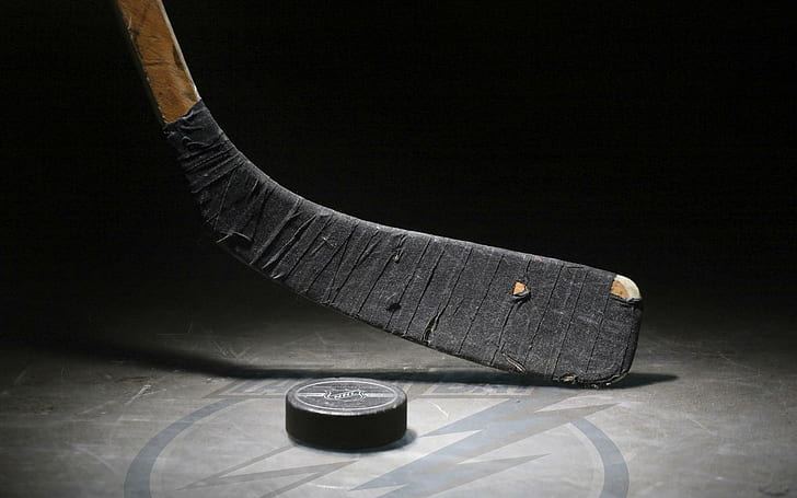 Stick blade and puck, shot low on the ice