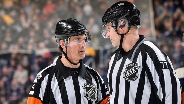 Officials conferring at the blue line