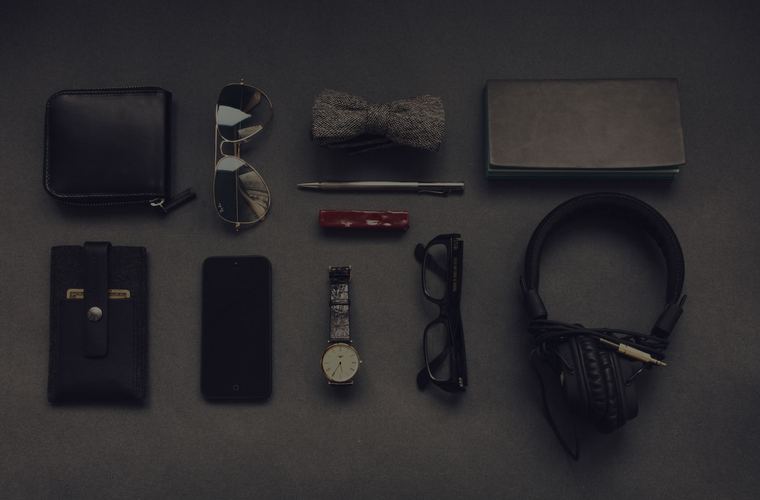 Camera equipment laid out flat on a dark surface