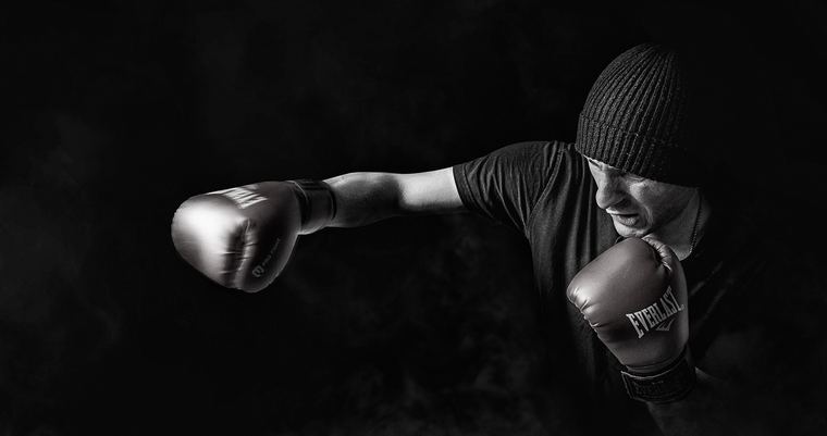 Boxer working the bag under a single light