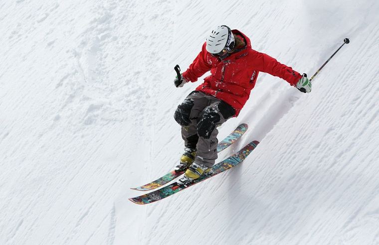 Skier carving through fresh snow