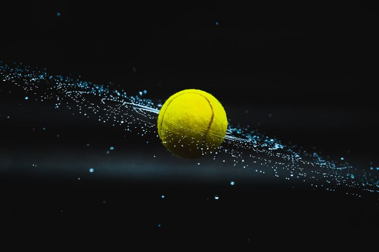 Ball frozen mid-flight against a dark backdrop