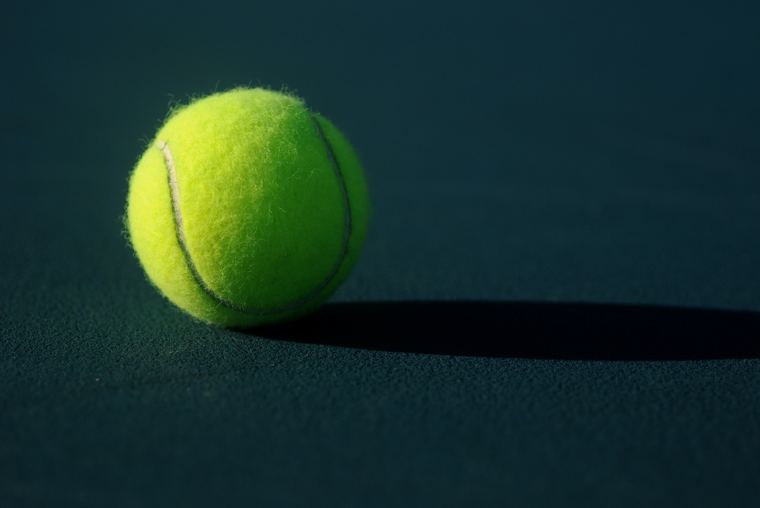 Ball and its shadow on a painted surface