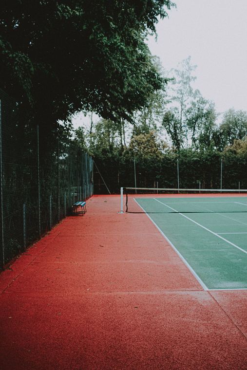 Clay and hard courts seen through the trees
